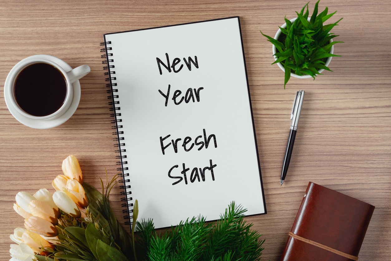 Notepad with wish list and coffee cup. New year's hope and resolution concept - New Year, Fresh Start.